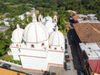 An aerial photo over an antique church that has three domes and is the second oldest of its kind in Latinamerica