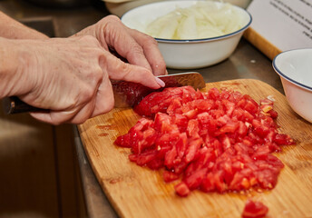 Sticker - Chef cuts the tomatoes into small cubes for cooking