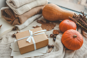 Gift box in autumn home interior