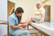 © alvaro - Elder woman with legs pain in a clinic