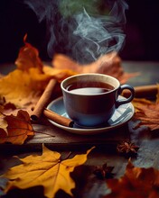 A Cup Of Hot Tea Stands On A Wooden Table Littered With Fall Leaves. Cinnamon Sticks