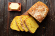 Flat lay view at homemade cornbread slices and butter on kitchen table