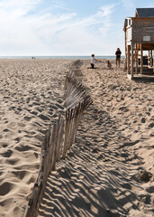  Dunes and wood fence with unidentified people in Scheveningen, the Hague, Holland.