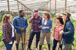 © Robert Kneschke - Multiracial farmers discussing over digital tablet at farm