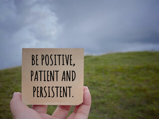 Wall Mural - Motivational and inspirational wording. Be Positive, Patient And Persistent written on a notepad. With blurred styled background.