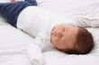 © New Africa - Cute newborn baby sleeping on white blanket, closeup