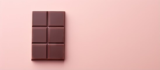 Canvas Print - A delicious chocolate bar alone on a isolated pastel background Copy space