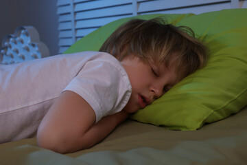 Wall Mural - Little boy snoring while sleeping on bed at night