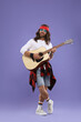 © New Africa - Stylish hippie man in sunglasses playing guitar on violet background