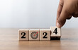 © GamePixel - 2024 Happy New year background. Businessman touch on 2024 target and goal for preparation new year change and start new. Setup objective target business cost and budget planning of new year concept.