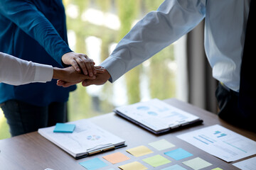 Sticker - group of businesspeople Show the symbol by stacking hands