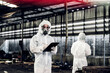 © kanpisut - Scientist wear Chemical protection suit check danger chemical, working at dangerous zone in Red and White Lines of barrier tape. Red and white Hazardous restricted area factory safety worker industry