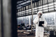 © kanpisut - Scientist wear Chemical protection suit check danger chemical, working at dangerous zone in Red and White Lines of barrier tape. Red and white Hazardous restricted area factory safety worker industry