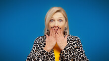 A Stylish Senior Woman Is Disappointed With Bad News And Is Covering Her Mouth With Her Hands