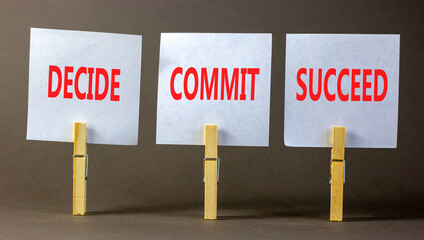 Wall Mural - Decide commit succeed symbol. Concept word Decide Commit Succeed on beautiful white paper on wooden clothespin. Beautiful grey table grey background. Business decide commit succeed concept. Copy space