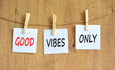 Good vibes only symbol. Concept word Good vibes only on beautiful white paper on wooden clothespin. Beautiful wooden table wooden background. Business motivational good vibes only concept. Copy space.