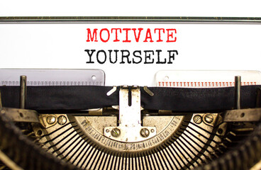 Motivate yourself symbol. Concept words Motivate yourself typed on beautiful old retro typewriter. Beautiful white paper background. Business psychology motivate yourself concept. Copy space.