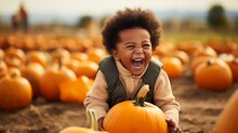 Happy Little African American Boy In A Pumpkin Patch In Autumn, Halloween Season Events, With Copy Space.