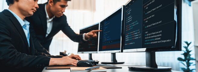 Wall Mural - software development team working together in office, coding script display on computer monitor. pro