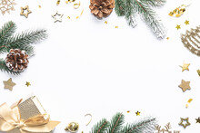 Festive Christmas And New Year Frame Made With Fir Tree Branches, Golden Stars, Pine Cones And Other Decorations On White Background With Copy Space For Your Text.