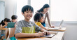 Pupil boy, teacher learn computer in classroom at elementary school. Student boy studying primary school. Children coding online in classroom. Education knowledge, successful teamwork concept banner