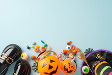 Lively Concept For Children's Halloween Nighttime. Top-down Photo Revealing Treats, Witch Costume Attributes And Eerie Decor On Isolated Blue Backdrop, Allowing Insertion Of Adverts Or Textual Matter