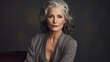 © lililia - a mature, confident woman with gray hair, gazing confidently at the camera against a studio backdrop. The composition emphasizes her inner strength and resilience, with space for meaningful text.