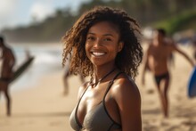 Young Black Woman With Curly Hair Wearing A Bikini In The Beach Looking To The Camera With A Smile