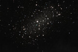 Fototapeta Kosmos - Silver abstract defocused glitter lights on black background, galaxy of lights and stars
