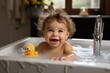 Infant taking a bubble bath with his toys
