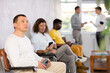 © JackF - Portrait of a focused European man sitting in a chair in the lobby waiting