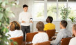 © JackF - Young man teacher reading lecture in front of group of guys attending him sitting on chairs