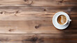 © Rexon Stock - Top view of a coffee cup next to a device with a blank screen on a wooden table, featuring ample space for text.