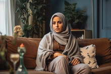 Sad Arabic Woman Sitting On Sofa And Being Bored While Watching Television