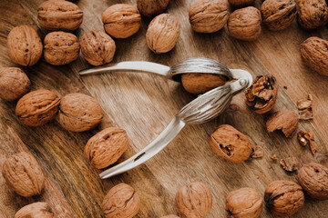 Wall Mural - Walnuts Abundance and metal nutcracker in a bowl . Healthy food and snacks.Healthy fats. Keto diet ingredient. Nuts and seeds. Useful healthy snack.