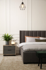 Wall Mural - Stylish bedroom interior with large comfortable bed and ottoman