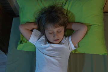 Sticker - Little boy snoring while sleeping in bed at night, top view