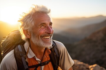 Wall Mural - Smiling portrait of a happy senior man hiker hiking in the forests and mountains