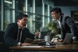 © jakapong - Business man sitting at office desk, boss shouting at him with angry moment.