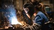 © visoot - Female welder, Woman in welding helmet working on piece of metal in workshop with sparks flying around.
