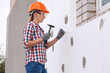 © Dmytro Titov - Insulation of the house with polyfoam. The worker is checking with the construction level the accuracy of the installation of polystyrene board on the facade.