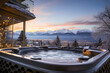 Hot bubbling tub with view of snow-covered mountain peaks.