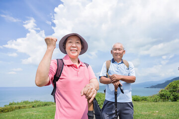 Wall Mural - Happy Senior couple hiking together on the mountain and coast