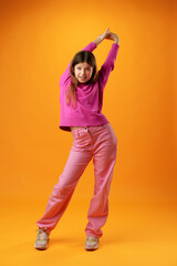 Full length portrait of a teen girl over yellow background