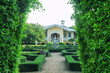 House and green buxus labyrinths in ornamental garden. Boxwood hedges maze in park