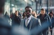 © CYBERUSS - Black Businessman Walking in Modern City, Handsome Man Walks on a Crowded Pedestrian Street, African Manager Surrounded by Blur People on Busy Street.