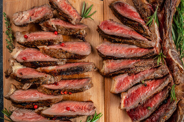 Wall Mural - Sliced grilled beef barbecue Striploin steak on a wooden board, Restaurant menu, dieting, cookbook recipe top view