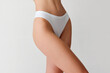 © Lustre Art Group  - Cropped image of slender, sporty female body in white underwear isolated over light studio background. Healthy eating.