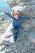 © ADDICTIVE STOCK CORE - Delighted boy on cliff near sea