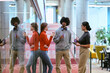 © .shock - Amidst the modern glass walls of a startup office, a diverse group of colleagues, including an African American man, engage in a coffee-fueled discussion, exemplifying collaboration and innovation in